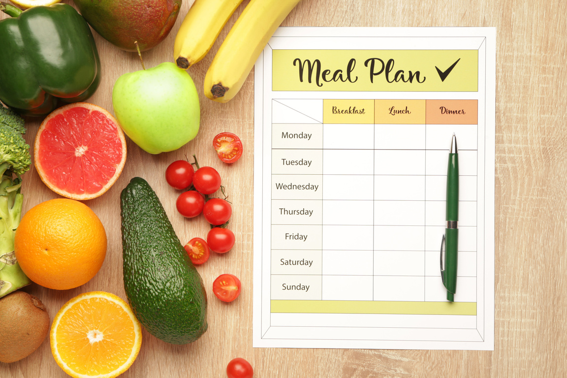 Healthy Products and Meal Plan on Wooden Background